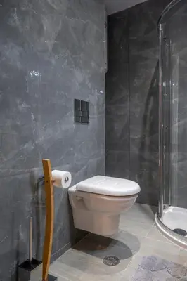 a bathroom with a toilet and a shower at Modern apt at Thisio next to the metro station in Athens