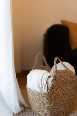 a basket filled with towels sitting on a floor at Prime location 1BR Hill Aprtm in Athens