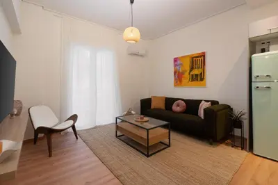 a living room with a couch and a table at Prime location 1BR Hill Aprtm in Athens