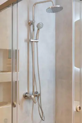 a shower with a shower head in a bathroom at Prime location 1BR Hill Aprtm in Athens
