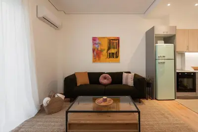 a living room with a couch and a table at Prime location 1BR Hill Aprtm in Athens