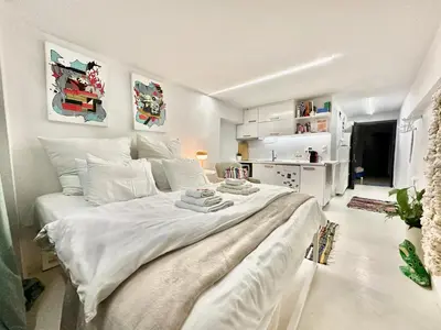 a bedroom with a large white bed in a room at Le Petit II Apartment in Athens