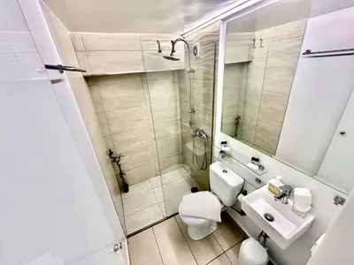 a bathroom with a toilet and a sink and a shower at Le Petit II Apartment in Athens