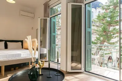 a bedroom with a bed and sliding glass doors at Neoclassical with Jacuzzi near Acropolis-Living Stone Aragonit in Athens