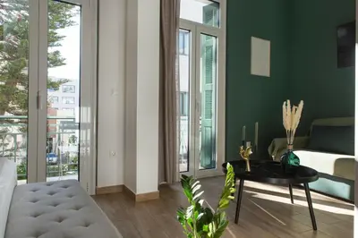 a living room with green walls and a table and a couch at Neoclassical with Jacuzzi near Acropolis-Living Stone Aragonit in Athens