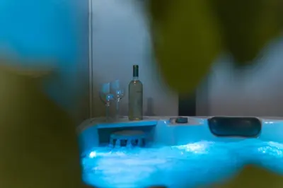 a blue sink with a bottle of wine and glasses at Neoclassical with Jacuzzi near Acropolis-Living Stone Aragonit in Athens