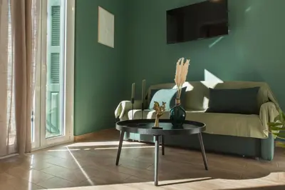 a living room with a couch and a table at Neoclassical with Jacuzzi near Acropolis-Living Stone Aragonit in Athens