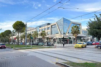 a building with a yellow car on a city street at Riviera Escape Penthouse Suites in Athens