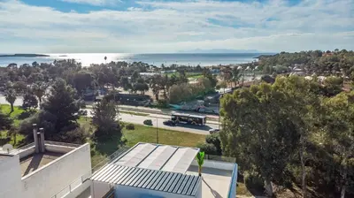 a view of the ocean from a house at Riviera Escape Penthouse Suites in Athens