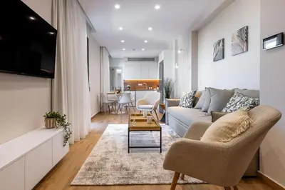 a living room with a couch and a table at Riviera Escape Penthouse Suites in Athens