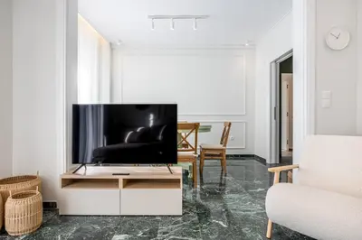 a living room with a flat screen tv on a table at The Emerald of Pagrati in Athens