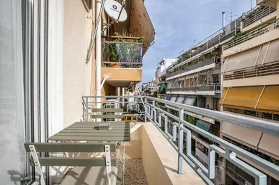 a balcony with tables and chairs on a building at The Emerald of Pagrati in Athens