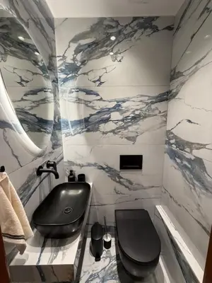 a bathroom with a black toilet and a sink at Sea View apartment in Athens