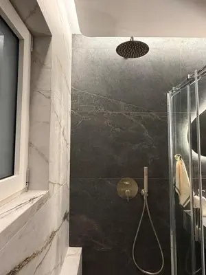 a bathroom with a shower with a glass door at Sea View apartment in Athens