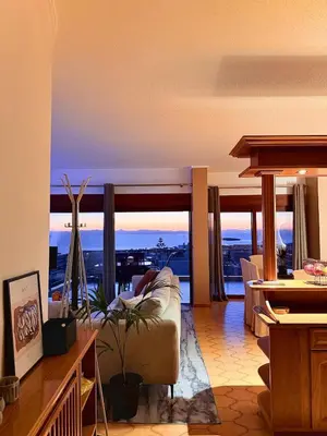 a living room with a couch and views of a city at Sea View apartment in Athens
