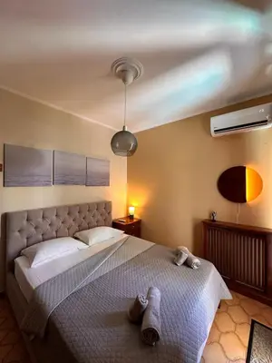 a bedroom with a large bed with two towels on it at Sea View apartment in Athens
