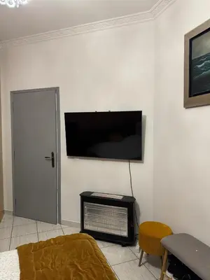 a living room with a flat screen tv on a wall at jo&ju new in Athens