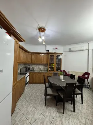 a kitchen with wooden cabinets and a table and chairs at jo&ju new in Athens