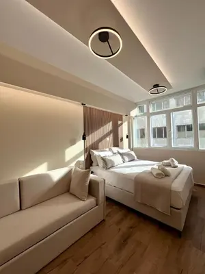 a bedroom with a large bed and a couch at Monastiraki 304 SuperHost Hub in Athens