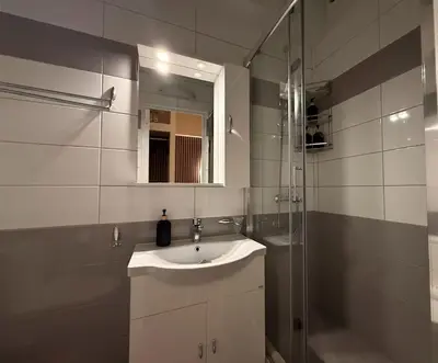 a white bathroom with a sink and a shower at Monastiraki 304 SuperHost Hub in Athens