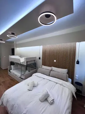 a bedroom with a large white bed with towels on it at Monastiraki 304 SuperHost Hub in Athens