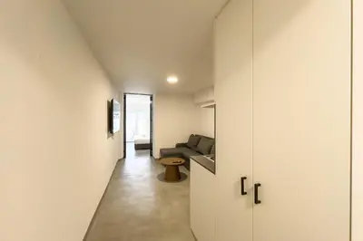 a hallway leading to a living room with a couch at Koukaki Urban Studio in Athens