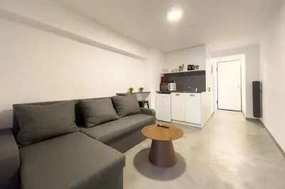 a living room with a couch and a table at Koukaki Urban Studio in Athens