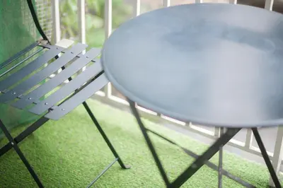 a white table and a chair sitting next to a table at Koukaki Urban Studio in Athens