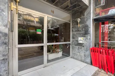a door to a store with red chairs outside at Koukaki Urban Studio in Athens