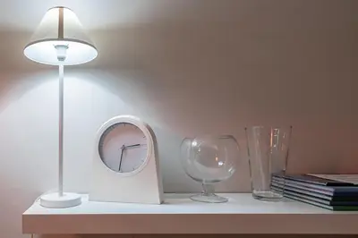 a table with a clock and a lamp and a glass at super central-metro Acropolis in Athens