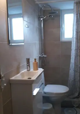 a bathroom with a sink and a toilet and a window at super central-metro Acropolis in Athens