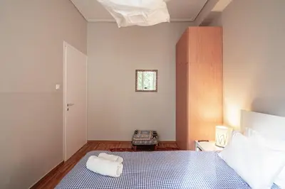 a bedroom with a bed with a blue and white at super central-metro Acropolis in Athens