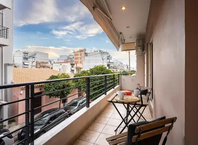 a balcony with a table and a view of a city at Entire Building for Big Groups in Athens in Athens
