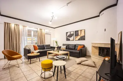 a living room with a couch and a fireplace at Entire Building for Big Groups in Athens in Athens