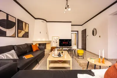 a living room with a couch and a table at Entire Building for Big Groups in Athens in Athens