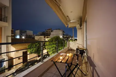 a balcony with a table and a view of the city at Entire Building for Big Groups in Athens in Athens