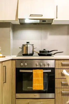 a stove with two pots on top of it in a kitchen at Entire Building for Big Groups in Athens in Athens