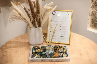 a table with a vase with flowers and a plate with a plant at DP Homes Exarcheia 1A in Athens