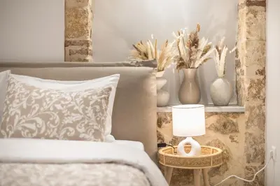 a bedroom with a bed and a table with a lamp at DP Homes Exarcheia 1A in Athens