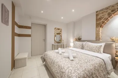 a bedroom with a large bed with two candles on it at DP Homes Exarcheia 1A in Athens