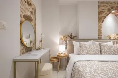 a white bedroom with a bed and a mirror at DP Homes Exarcheia 1A in Athens