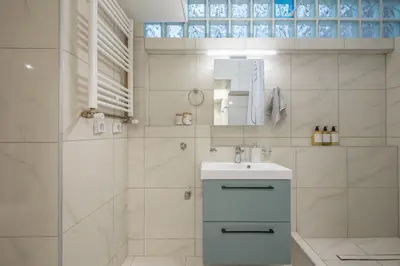 a white bathroom with a sink and a shower at DP Homes Exarcheia 1A in Athens