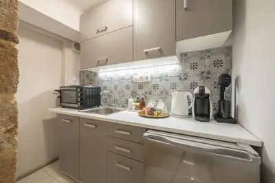 a small kitchen with a sink and a microwave at DP Homes Exarcheia 1A in Athens