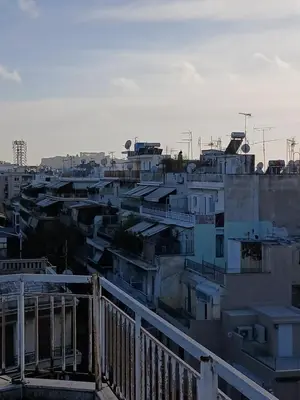 a view of a city with houses and buildings at Acropolis Skyline Sunset, 2 person loft Exarchia in Athens