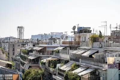 an overhead view of a city with buildings at Acropolis Skyline Sunset, 2 person loft Exarchia in Athens