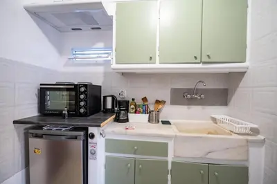 a kitchen with a sink and a microwave at Acropolis Skyline Sunset, 2 person loft Exarchia in Athens