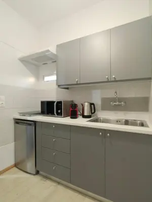 a kitchen with stainless steel cabinets and a sink at Acropolis Skyline Sunset, 2 person loft Exarchia in Athens