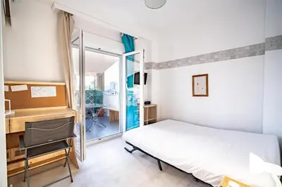 a bedroom with a bed and a desk and a window at Acropolis Skyline Sunset, 2 person loft Exarchia in Athens
