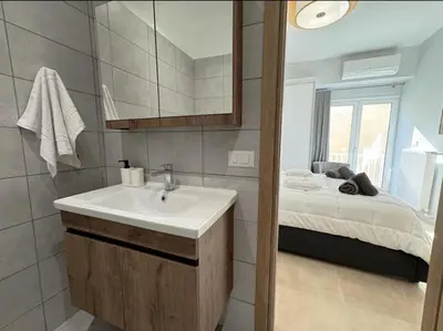 a bathroom with a sink and a bed at Elegant VIP Apartment - Athens Town in Athens