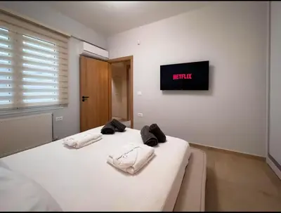 a bedroom with a bed with two towels on it at Elegant VIP Apartment - Athens Town in Athens